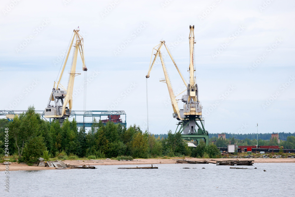 Heavy cranes in the port on the lake
