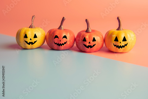 Halloween concept, Four Pumpkin with smile face on pastel colors background.