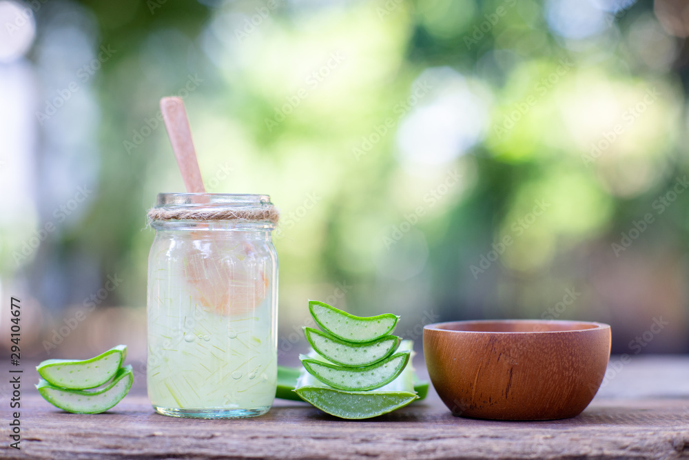 Fresh aloe vera stem slices and gel on wooden table, skin therapy concept Fresh aloe vera stem slices and gel on wooden table, skin therapy concept