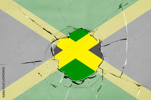 Flag of Jamaica on a on glass breakage. photo