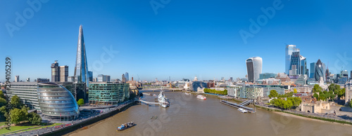 Aerial cityscape panorama of the Thames river on a sunny day with the City Hall, Shard skyscraper and London City Financial district skyline.
