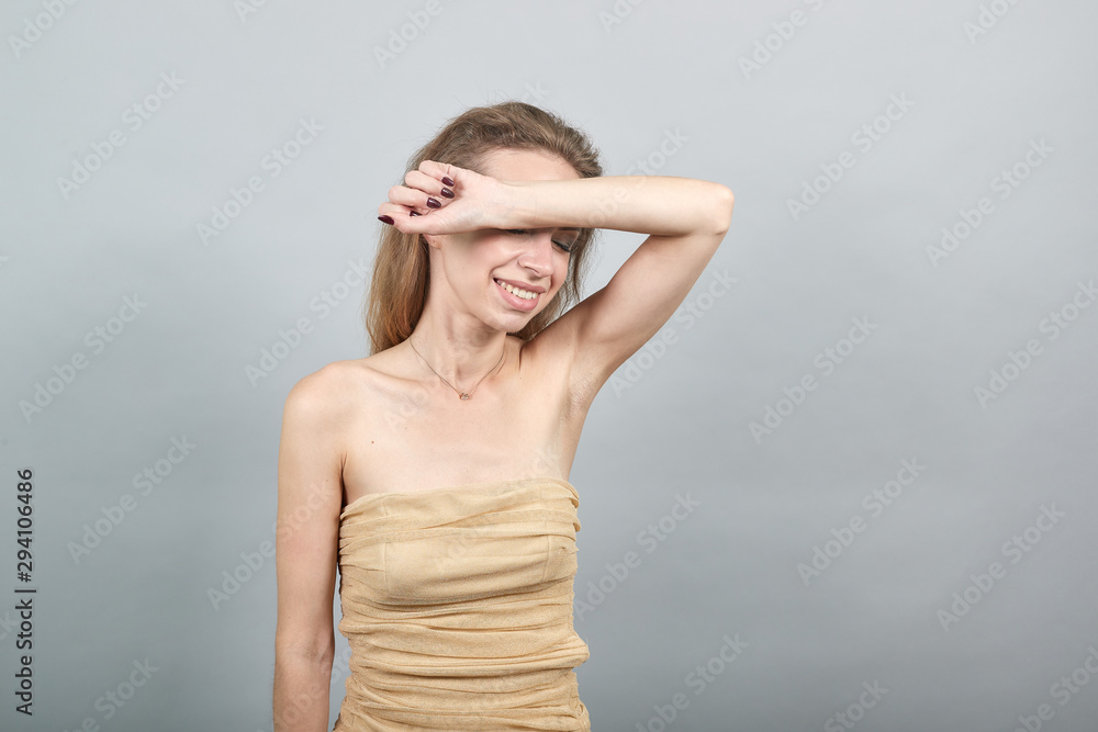 Beautiful girl in beige t-shirt over isolated white background shows emotions Beautiful girl in beige t-shirt over isolated white background shows emotions