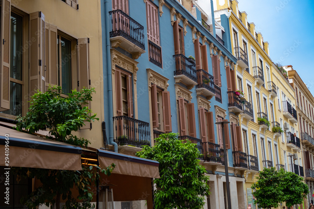 Naklejka premium Decorated exteriours residental buildings in Malaga city, Andalusia, Spain. It's a popular shopping destination for tourists and locals