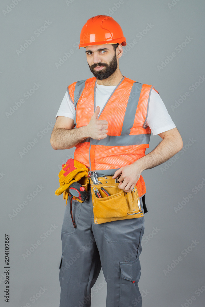 Studio portrait of a Builder, on a gray background Studio portrait of a Builder, on a gray background