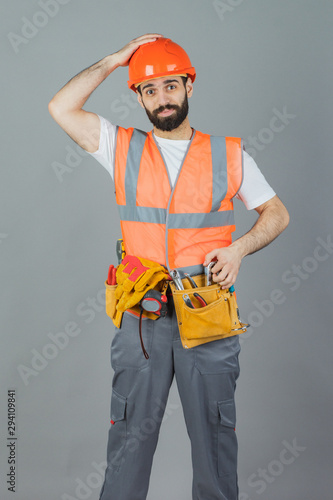 Studio portrait of a Builder, on a gray background © fusssergei