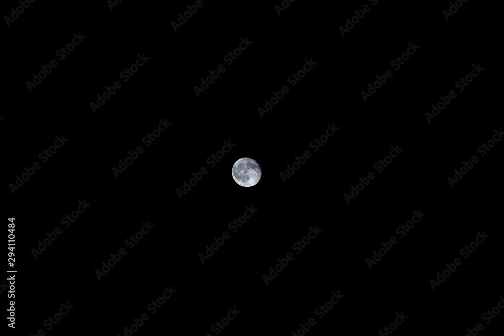 A small moon shining in the night sky A small moon shining in the night sky