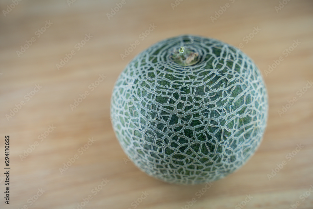 selected focus of fresh green Melon on wooden background selected focus of fresh green Melon on wooden background