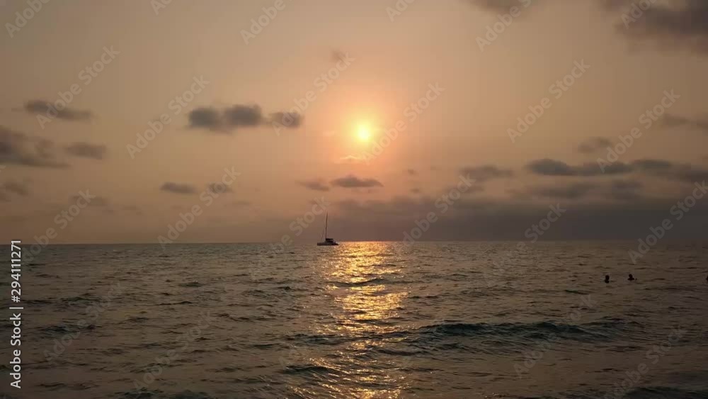 Aerial view shot from drone of the ocean at sunrise Sailboat sunset fantasy with a silhouetted boat sailing. Yachting tourism. maritime evening walk. Romantic on luxury yacht during the sea sunset. Aerial view shot from drone of the ocean at sunrise Sailboat sunset fantasy with a silhouetted boat sailing. Yachting tourism. maritime evening walk. Romantic on luxury yacht during the sea sunset.