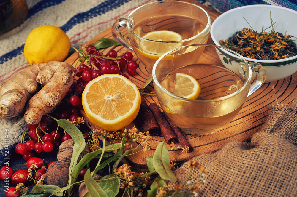 Two cups of medicinal herbal tea with ginger, lemon, cinnamon and lime.  Tonic and therapeutic hot drinks .