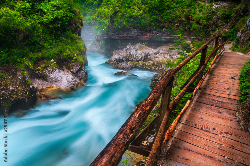 Admirable Radovna river in Vintgar canyon and wooden footbridge, Slovenia Admirable Radovna river in Vintgar canyon and wooden footbridge, Slovenia