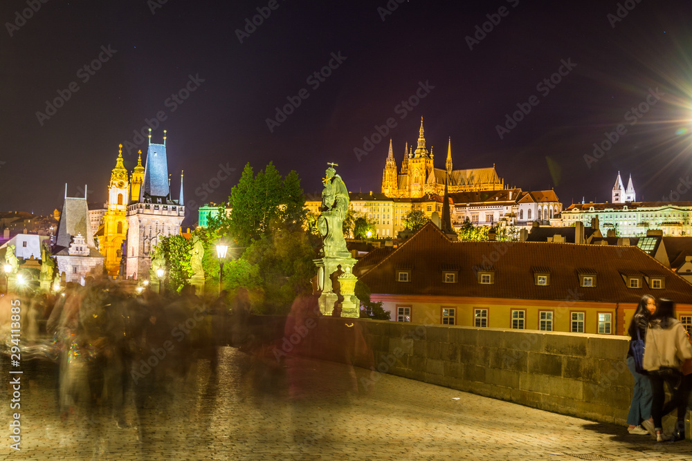 NIght view of the Lesser Town Bridge Tower, form the entrance to the Lesser Town from Charles Bridge, and Prague Castle, the biggest Castle in the world.