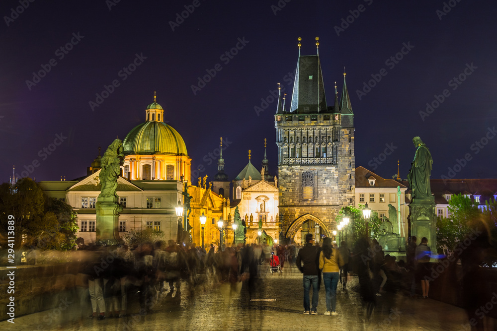 Night view of  Old Town Bridge Tower and background of  Church of St Francis Seraph at the bank of River Vltava, view from the Charles bridge.