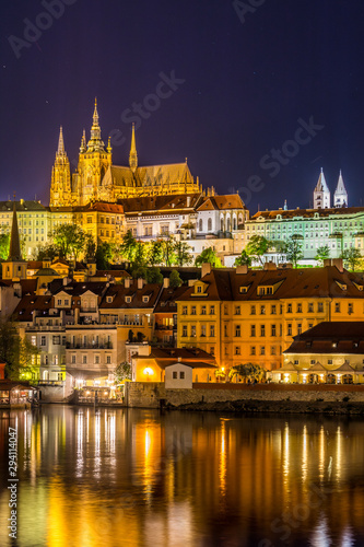 Night View of Prague castle, the largest coherent castle complex in the world, with the reflection on Vltava river.