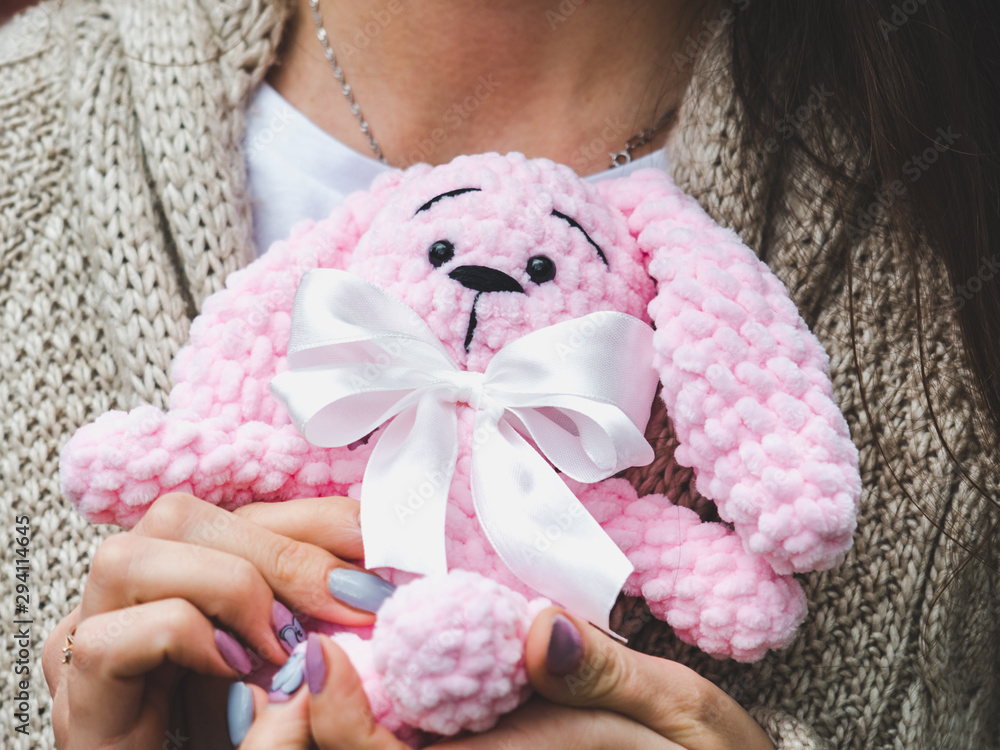 Cute young woman holding a stuffed toy in her hands Cute young woman holding a stuffed toy in her hands