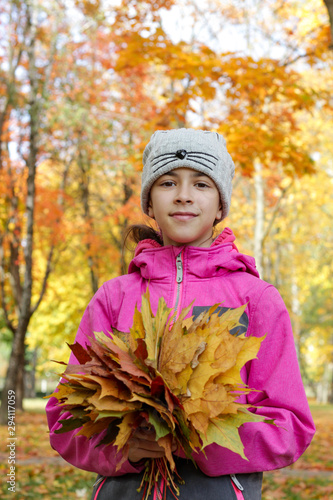 happy boy and girl are walking in the autumn park