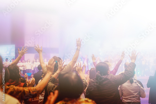 Soft focus of Christian worship with raised hand,m