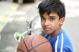 Portrait of Indian boy holding basketball