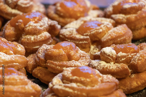 Hungarian home made pastry called rózsafánk rose pastry or doughnuts after frying with powdered sugar and apricots marmalade topping 