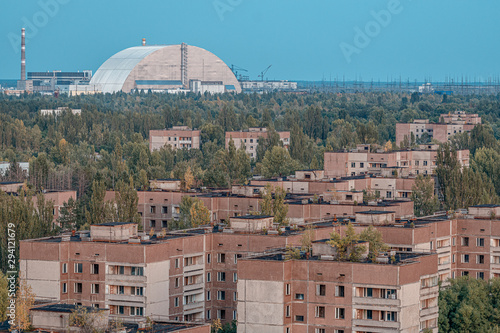 Valokuvatapetti view of the new safe confinement arch at the Chernobyl nuclear power plant through the prospect of abandoned Pripyat