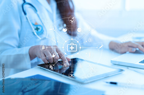 Fototapeta Naklejka Na Ścianę i Meble - Medicine doctor or medical students with stethoscope using digital tablet laptop,Health Check with digital system support for patient with medical icon at hospital, Medical network technology concept.