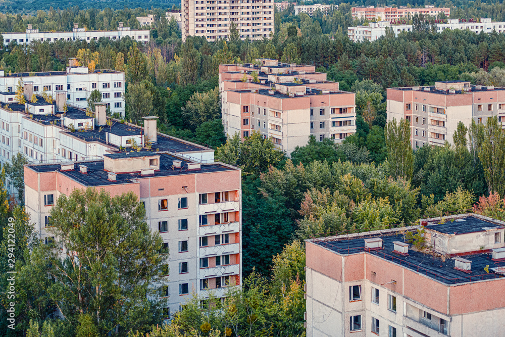 aerial view of the lost city of Pripyat. a lot of empty concrete floors overgrown with trees. Pripyat is empty after the evacuation for 33 years after the accident at the Chernobyl nuclear power plant