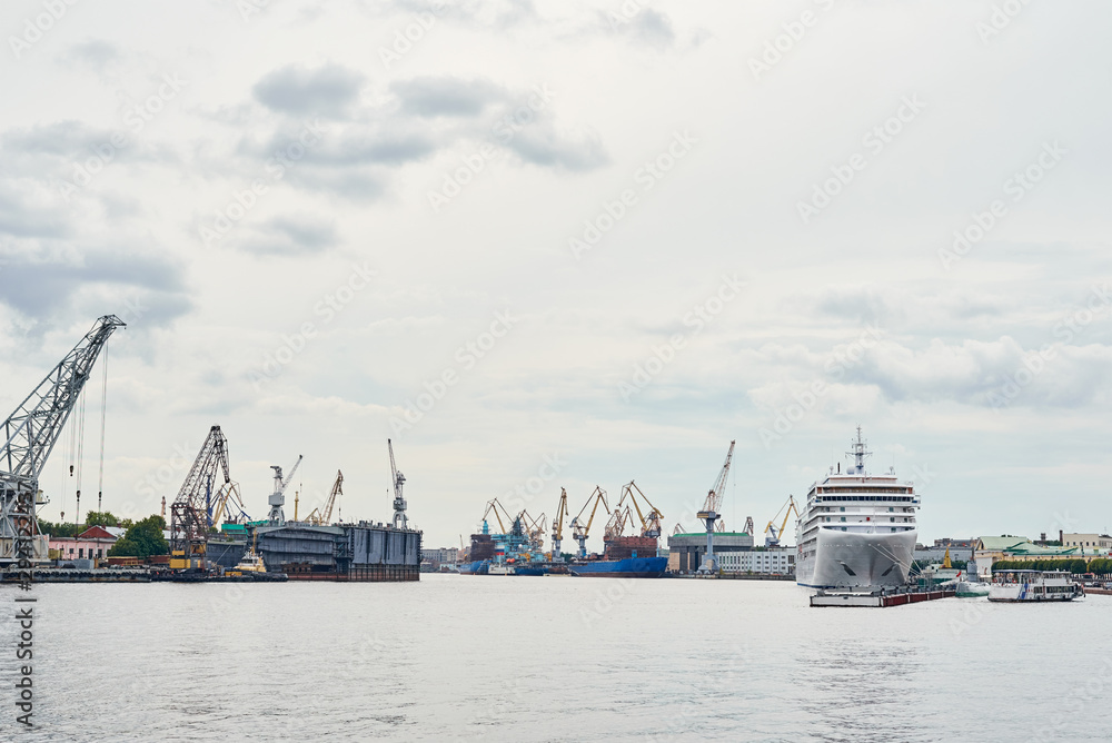 working crane bridge in shipyard and cargo ships in a port working crane bridge in shipyard and cargo ships in a port