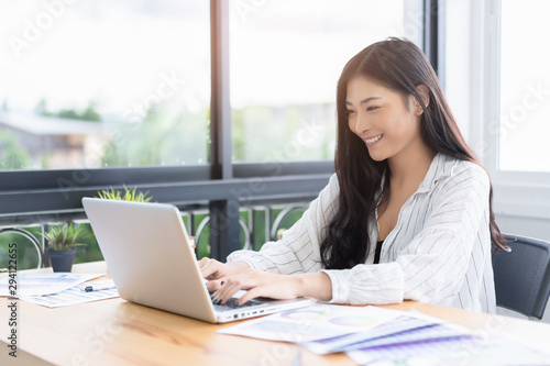 Asian young business women working with new project modern loft,laptop in coffee shop cafe, Analyze plans, papers, hands texting keyboard.Generic design notebook,technology or startup business concept © Have a nice day 