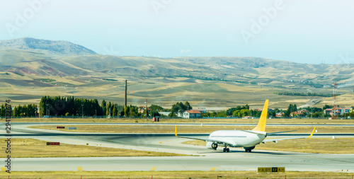 airplane on airport runway under dramatic sky. Aviation technology and world travel concept. Airplane taking off from the airport - Travel by air transport
