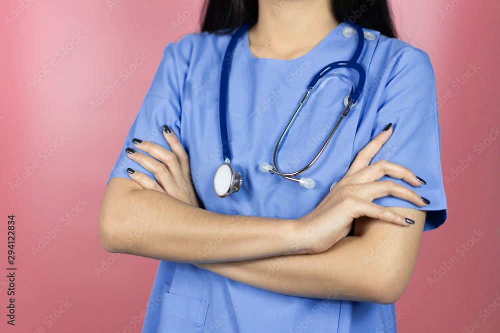 Doctor surgeon posing with arms crossed with stethoscope in an operating theatre,surgical room,success smart medical doctors,healthcare and medically ,Pink background banner Doctor surgeon posing with arms crossed with stethoscope in an operating theatre,surgical room,success smart medical doctors,healthcare and medically ,Pink background banner