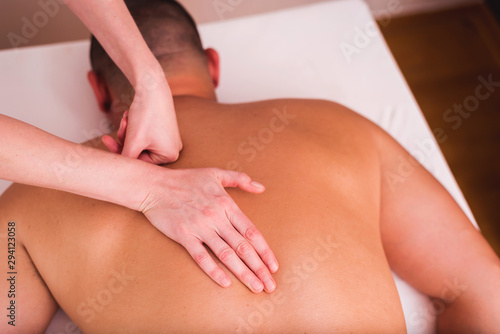 Man enjoying sports massage at spa photo