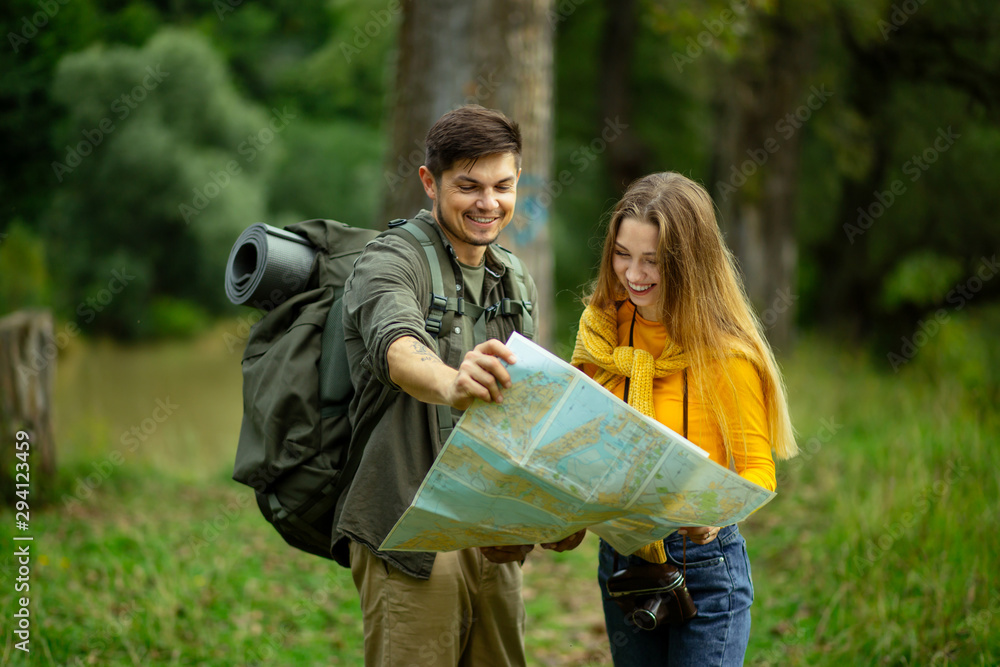 positive motivated active ouple with backpacks looking at map, active healthy lifestyle, hobby, interest, happiness positive motivated active ouple with backpacks looking at map, active healthy lifestyle, hobby, interest, happiness