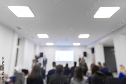 unfocused co working office interior space with people silhouettes in workshop time, symmetry lamp illumination frame empty copy space for text