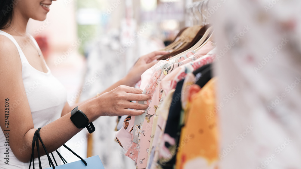 Young and attractive woman is in shopping and choosing clothes. Young and attractive woman is in shopping and choosing clothes.