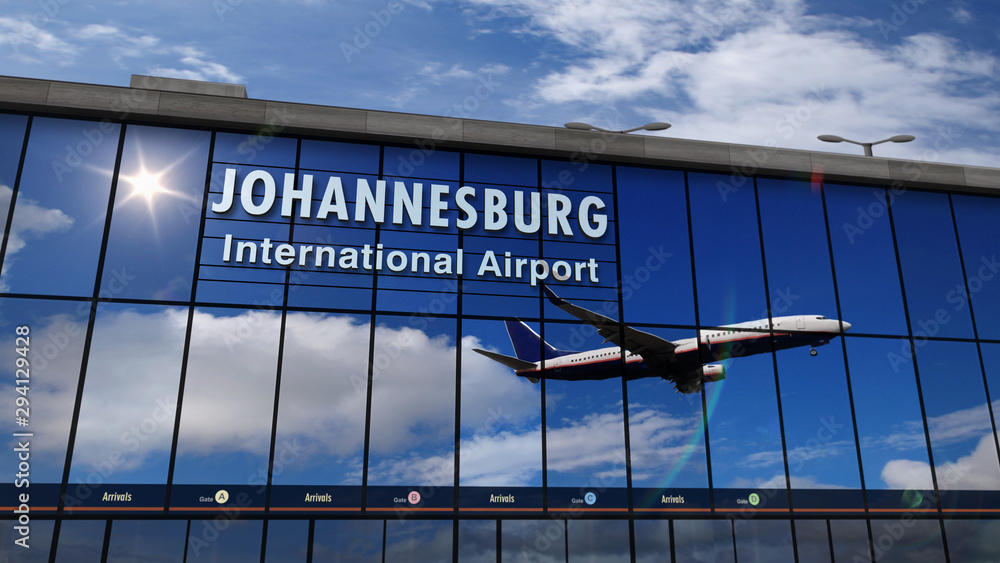 Obraz premium Samolot lądujący w Johannesburgu odbity w terminalu