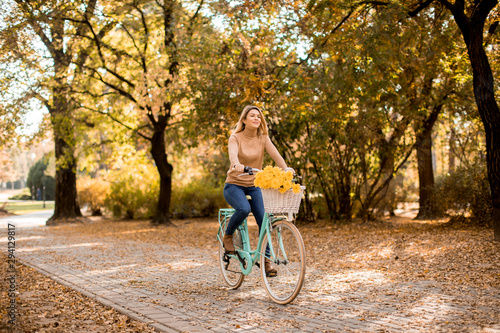 Young woman riding bicycle ...