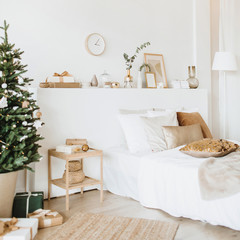 Modern interior design bedroom with Christmas / New Year decorations, toys, gifts, fir tree. Winter holidays composition.