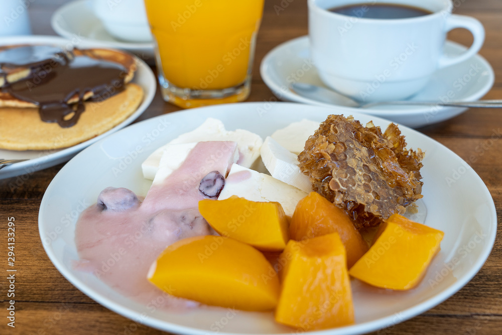 Breakfast of many dishes and drinks on a wooden table, closeup. Food concept Breakfast of many dishes and drinks on a wooden table, closeup. Food concept