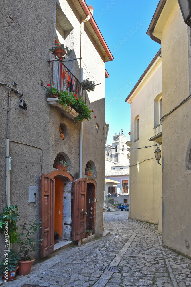 Fototapeta premium The road between the old houses of a village in the mountains of southern Italy
