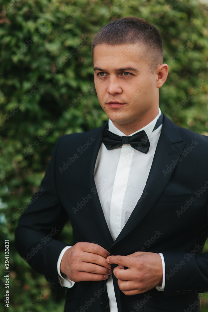 Handsome groom dressed his wedding blazer. autumn weather Handsome groom dressed his wedding blazer. autumn weather