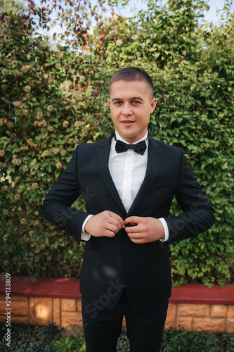 Handsome groom dressed his wedding blazer. autumn weather photo