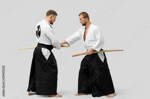 Two caucasian men are practicing aikido with Bokken (isolation path included) photo