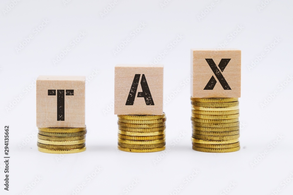 © MuhaiminAzfar - Tax concept with wooden block on stacked coin © MuhaiminAzfar - Tax concept with wooden block on stacked coin