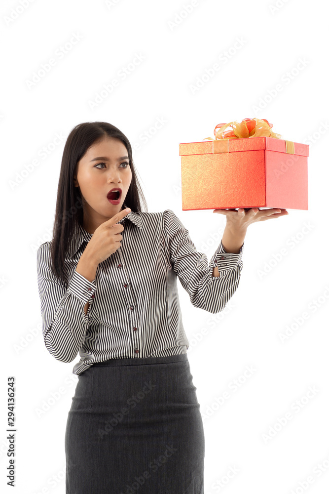 Asian young lady holding beautiful red present box with curious and surprise facial expression. Portrait of business woman looking and one finger pointing to the gift, isolated on white background. Asian young lady holding beautiful red present box with curious and surprise facial expression. Portrait of business woman looking and one finger pointing to the gift, isolated on white background.