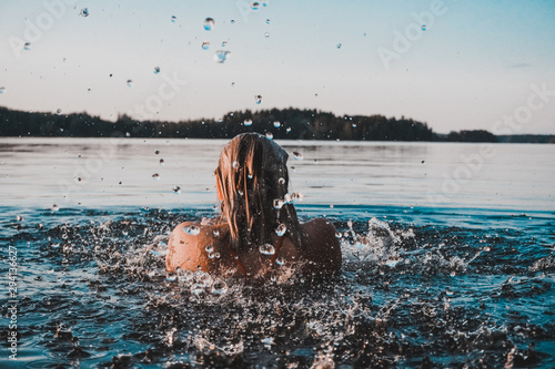 Fototapeta Finnish Girl in a Lake swimming, blue, Finland, summer
