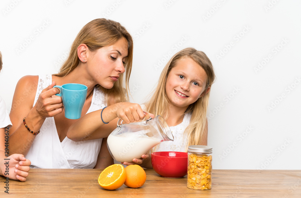Mother with her two children having breakfast Mother with her two children having breakfast
