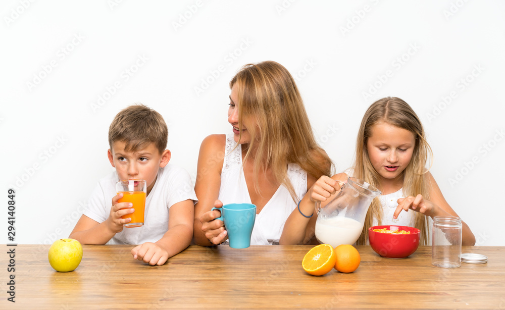 Mother with her two children having breakfast Mother with her two children having breakfast