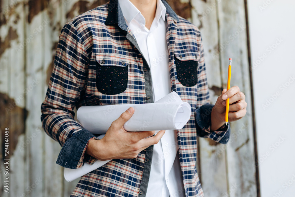 Engineer or Architect holding personal architectural drawing Engineer or Architect holding personal architectural drawing