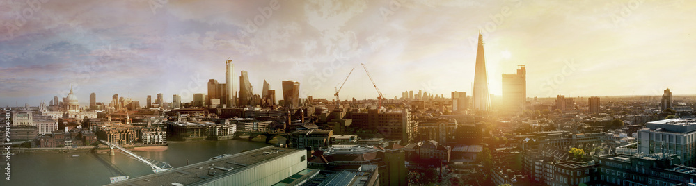 London view at sunset panorama. River thames, millennium bridge, St. Paul's cathedral, modern skyscrapers of the City, Canary Wharf at the background and Tate modern tower. UK, 2019