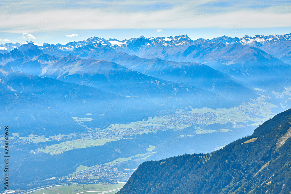 Obraz premium Mountain landscape in Austria, cloudy, forests, rocks, city in the mountains, summer