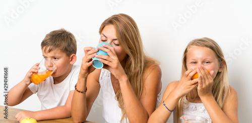 Mother with her two children having breakfast